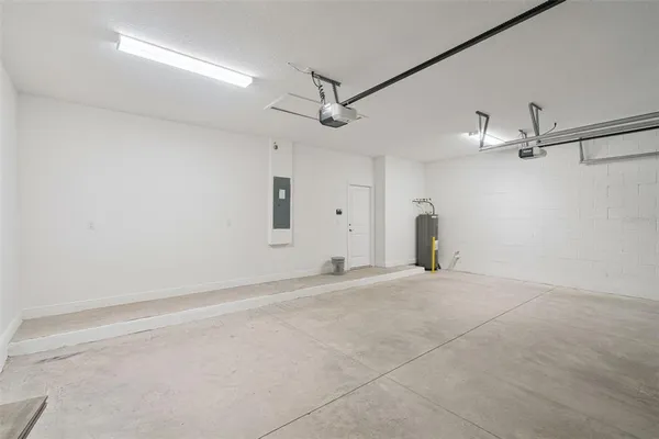 an empty room with ceiling fan and window