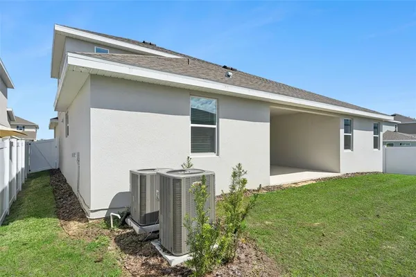 a backyard of a house with table and chairs