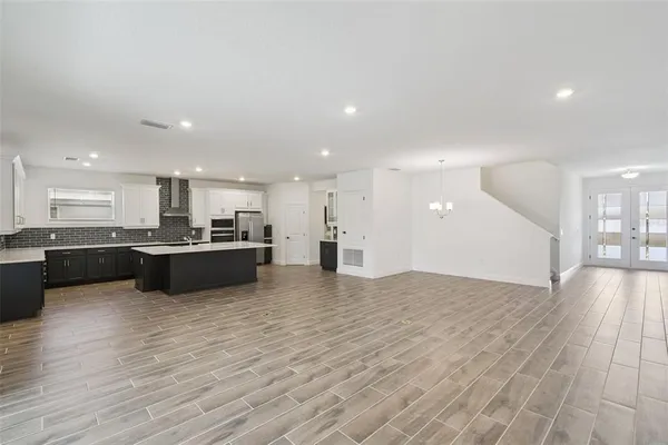a view of kitchen with kitchen island and stainless steel appliances