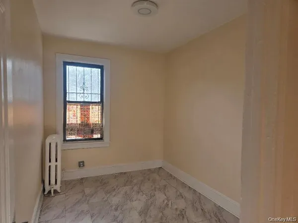 an empty room with windows and closet