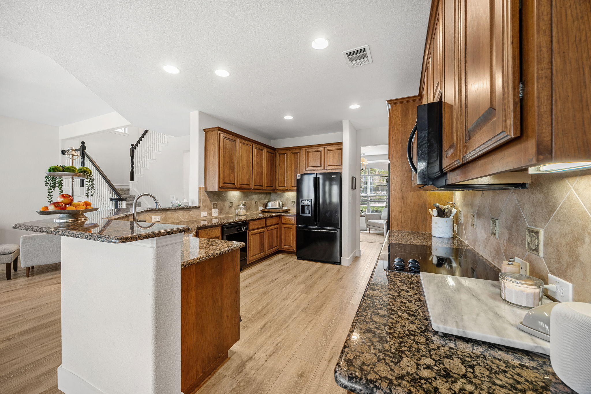 128 Las Colinas Drive Georgetown, TX 78628 - Photo 11 of 38 a kitchen with stainless steel appliances granite countertop a sink refrigerator and cabinets