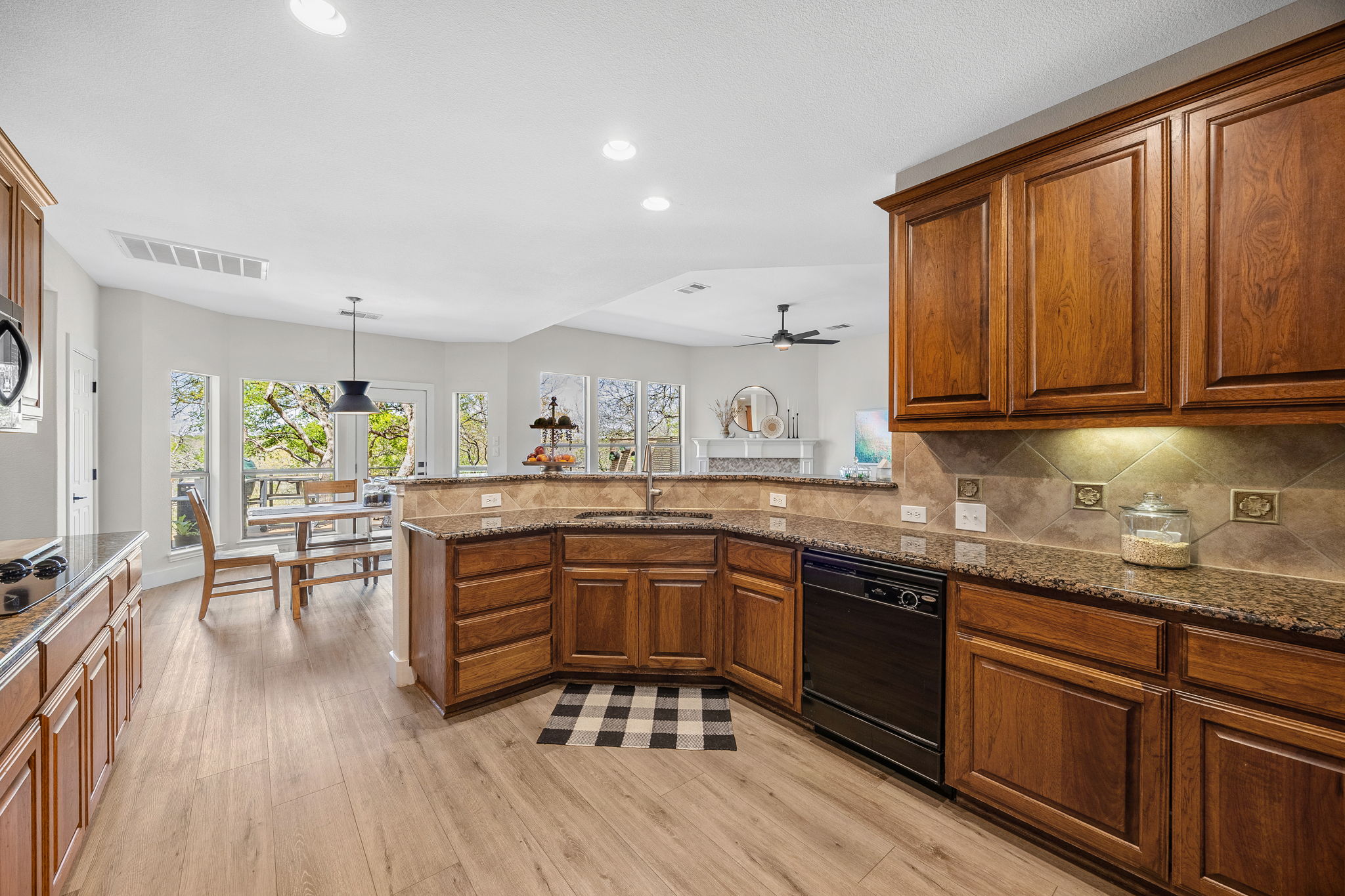 128 Las Colinas Drive Georgetown, TX 78628 - Photo 12 of 38 a kitchen with sink cabinets and wooden floor