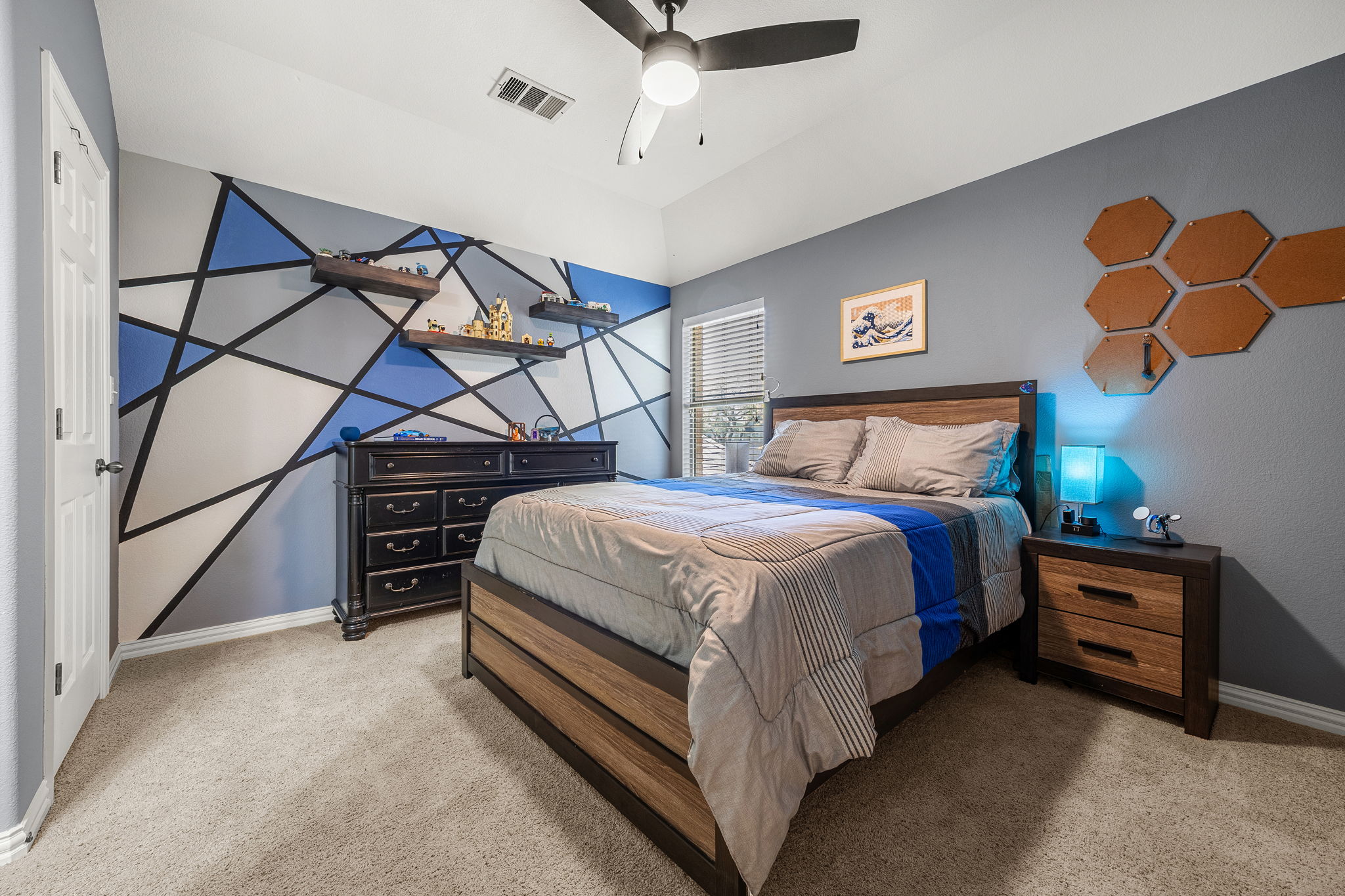 128 Las Colinas Drive Georgetown, TX 78628 - Photo 20 of 38 a bedroom with a bed and a chandelier