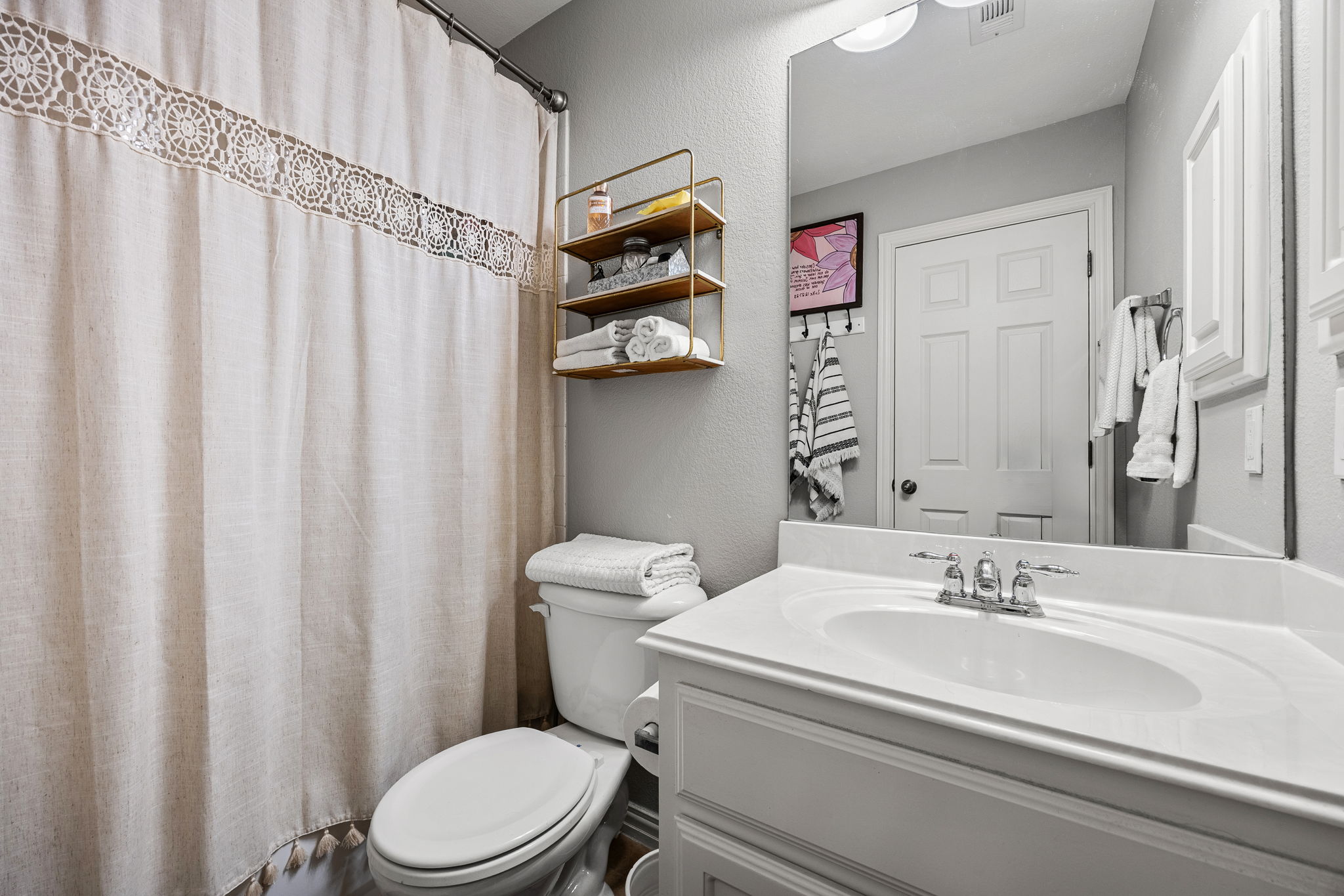 128 Las Colinas Drive Georgetown, TX 78628 - Photo 29 of 38 a bathroom with a sink a toilet and shower curtain