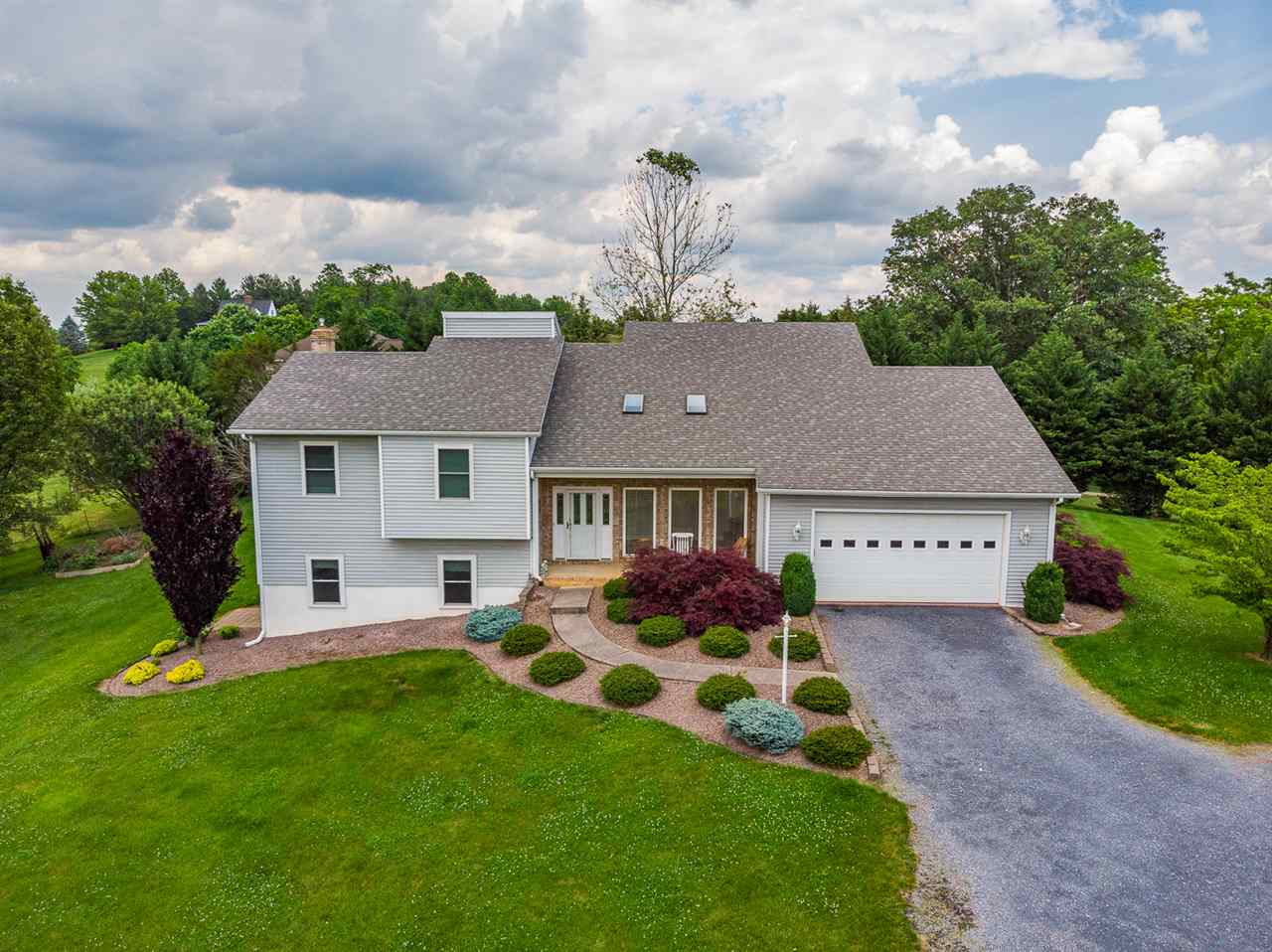 285 Fadley Road Weyers Cave, VA 24486 - Photo 1 of 30 a front view of a house with garden
