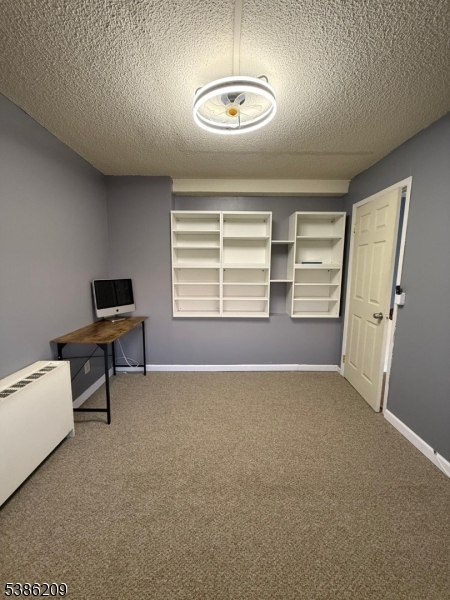 277 Prospect Avenue, Unit H Hackensack, NJ 07601 - Photo 11 of 25 a living room with furniture and a window