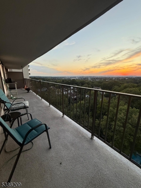 277 Prospect Avenue, Unit H Hackensack, NJ 07601 - Photo 16 of 25 a view of a terrace with two chairs and a table