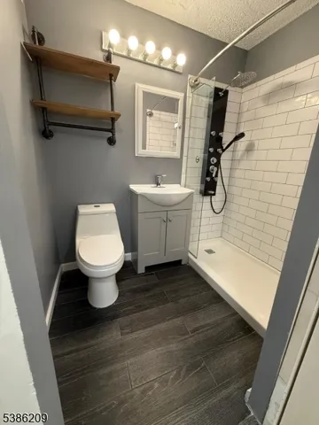 a bathroom with a shower and a sink