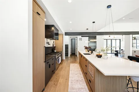 a large kitchen with kitchen island a large counter space a sink and stainless steel appliances