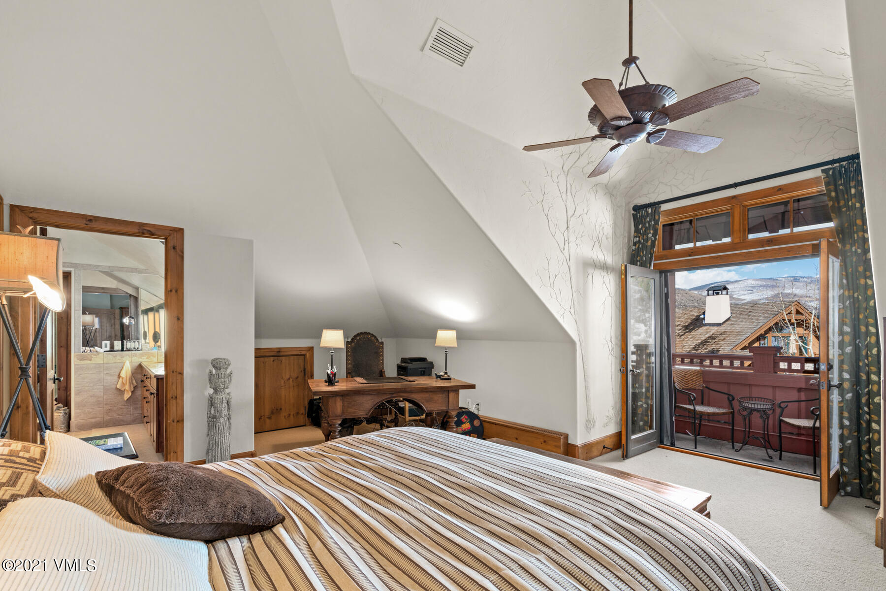 160 Cresta Road, Unit R501 Edwards, CO 81632 - Photo 14 of 21 a bedroom with a bed and a chandelier