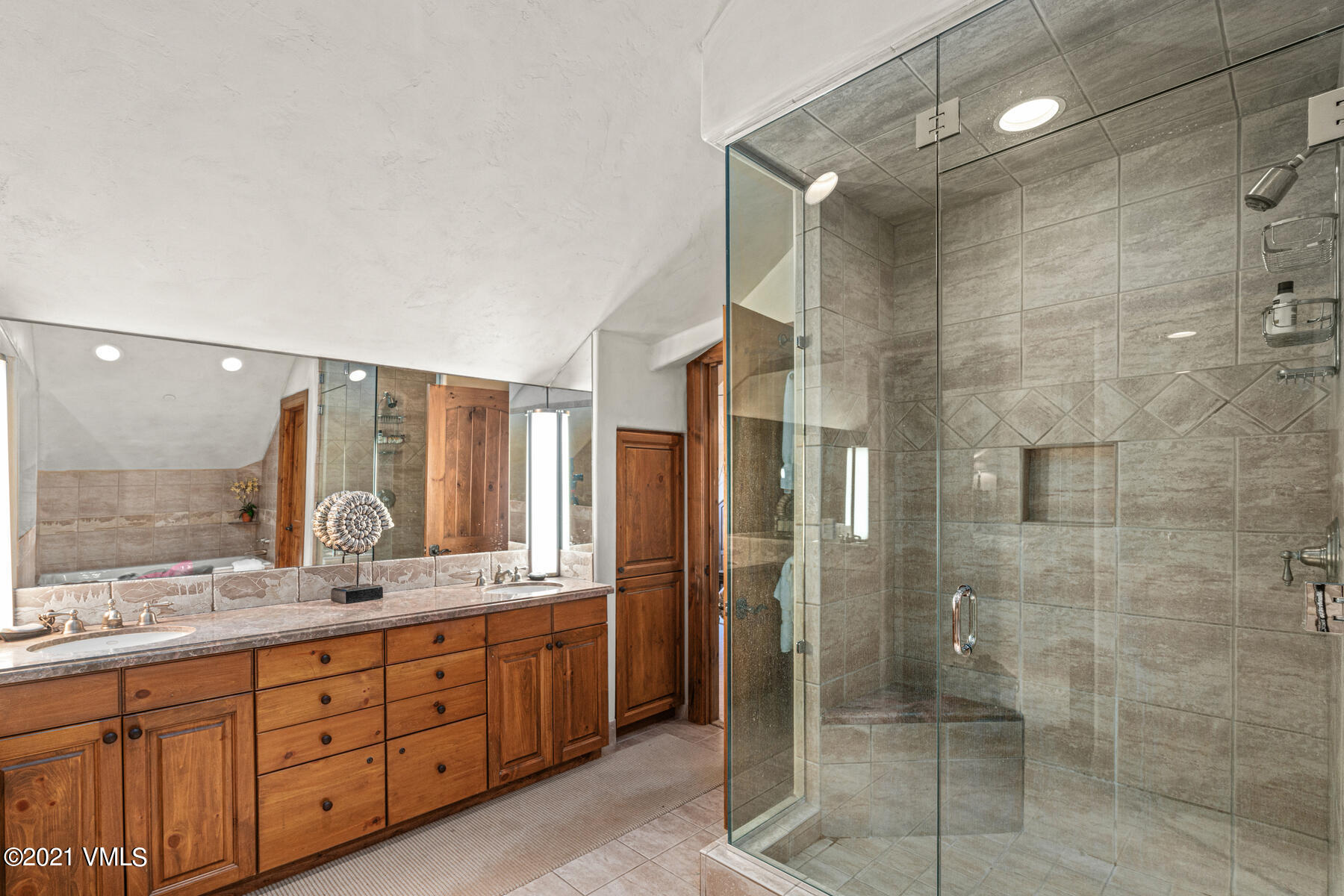 160 Cresta Road, Unit R501 Edwards, CO 81632 - Photo 15 of 21 a bathroom with a granite countertop sink mirror and shower