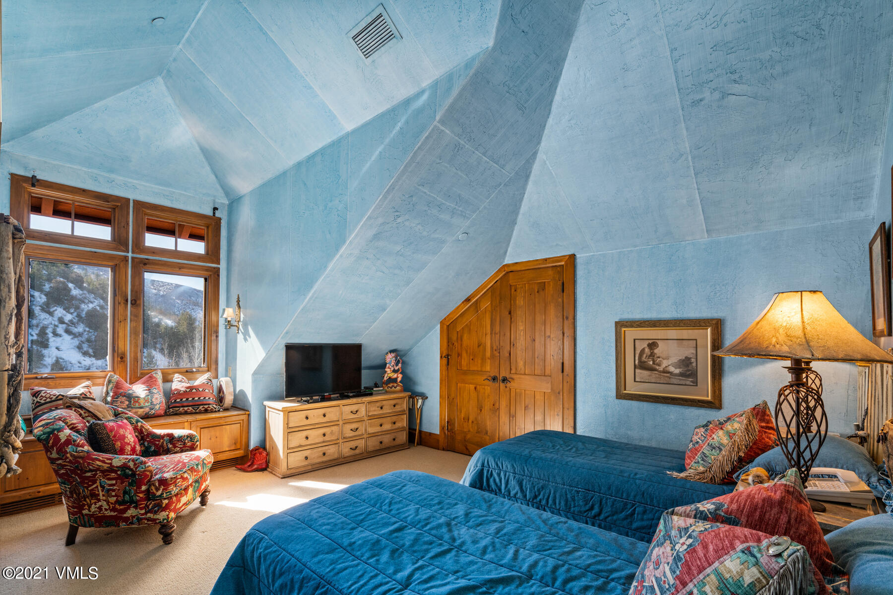 160 Cresta Road, Unit R501 Edwards, CO 81632 - Photo 20 of 21 a bedroom with furniture and a flat screen tv