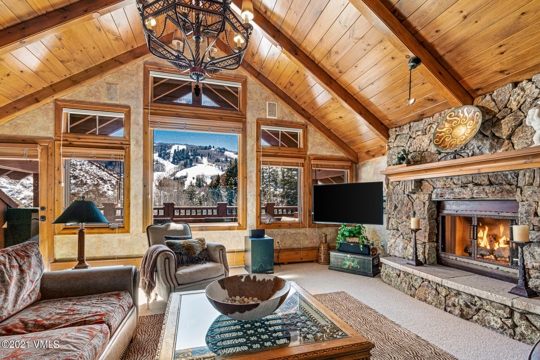 160 Cresta Road, Unit R501 Edwards, CO 81632 - Photo 7 of 21 a living room with furniture a flat screen tv and a fireplace