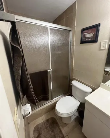 a bathroom with a toilet and a shower