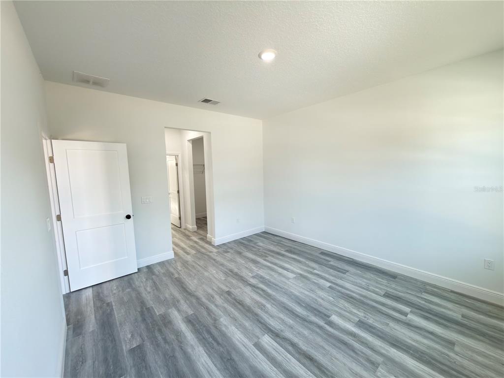 3901 Southwest 161st Loop Ocala, FL 34473 - Photo 14 of 47 a view of an empty room and wooden floor