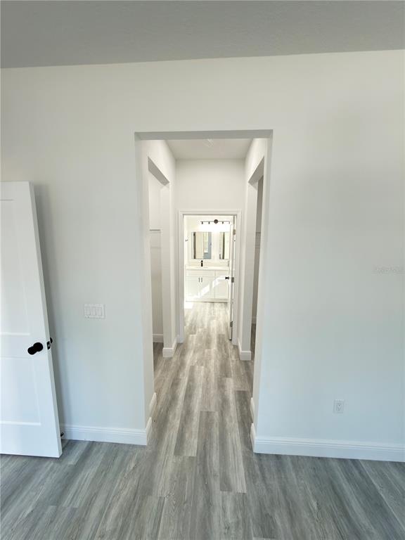3901 Southwest 161st Loop Ocala, FL 34473 - Photo 15 of 47 a view of a hallway view with wooden floor and staircase