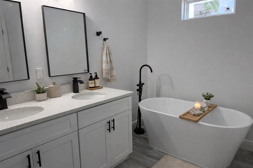3901 Southwest 161st Loop Ocala, FL 34473 - Photo 18 of 47 a bathroom with a tub sink and mirror