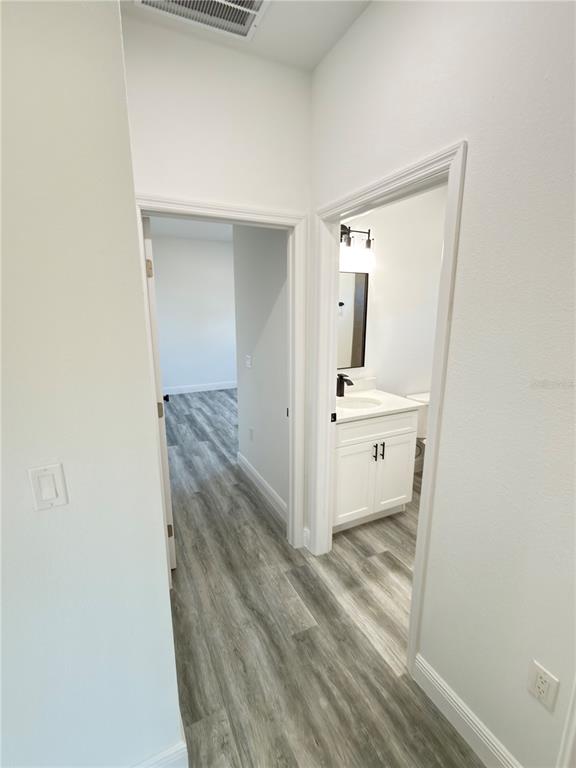 3901 Southwest 161st Loop Ocala, FL 34473 - Photo 34 of 47 a view of a hallway to a room with wooden floor