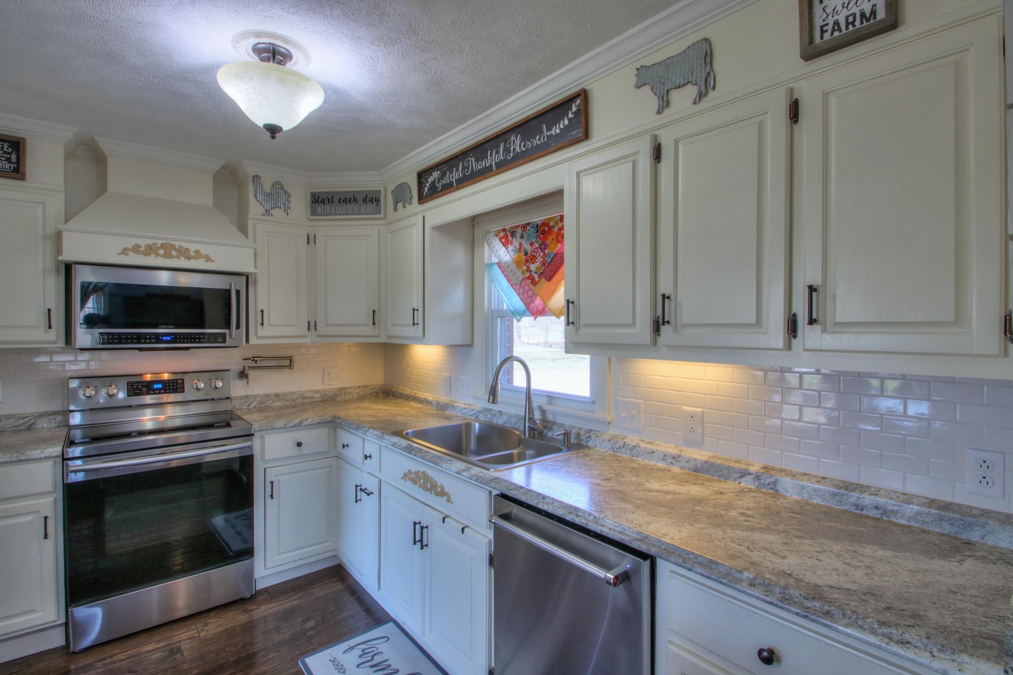 258 Cedar Park Road Centerville, TN 37033 - Photo 10 of 30 New countertops and sleek subway tile backsplash.