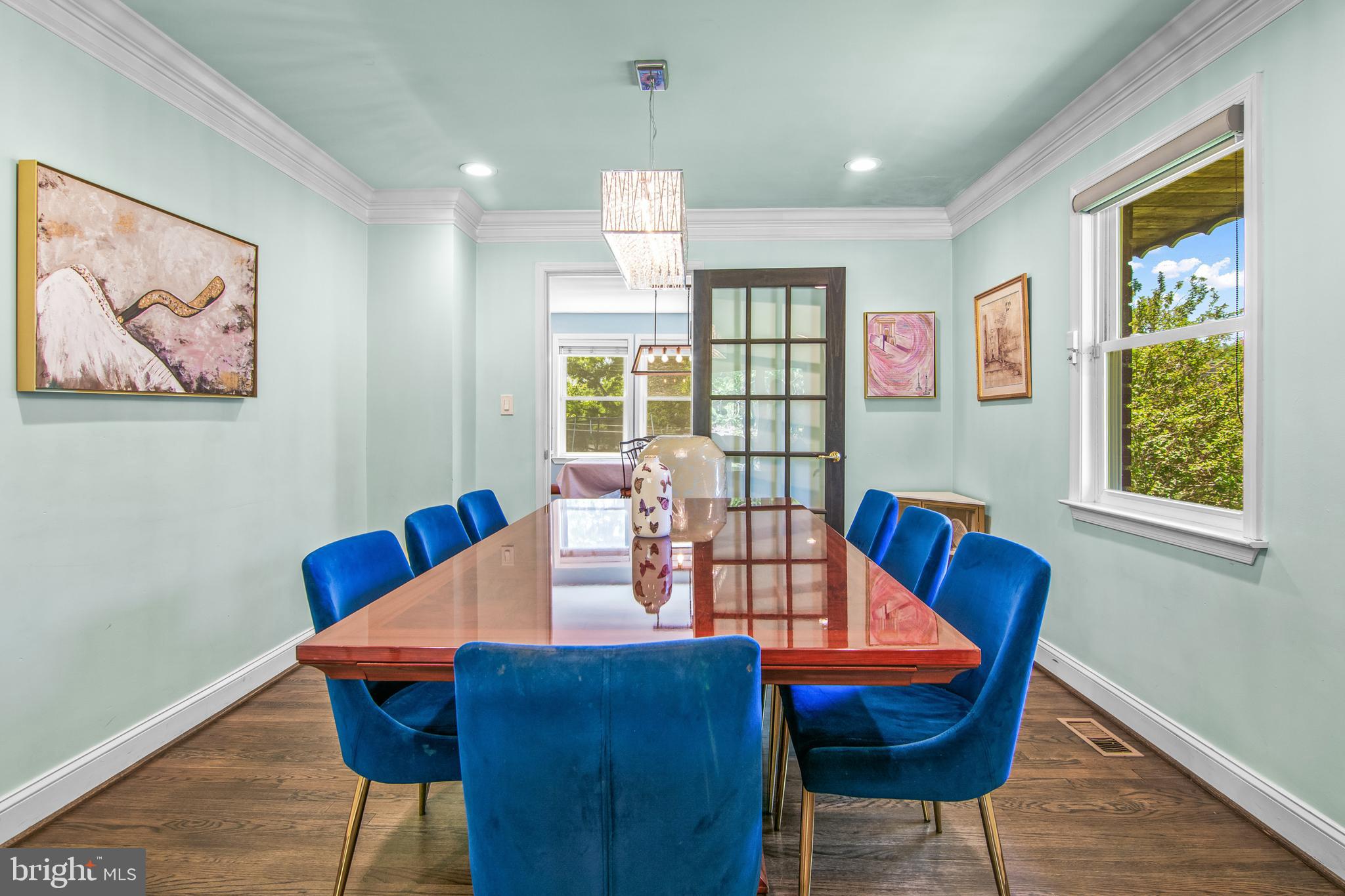 6308 Ivymount Road Baltimore, MD 21209 - Photo 4 of 22 a view of a dining room with furniture a chandelier and wooden floor