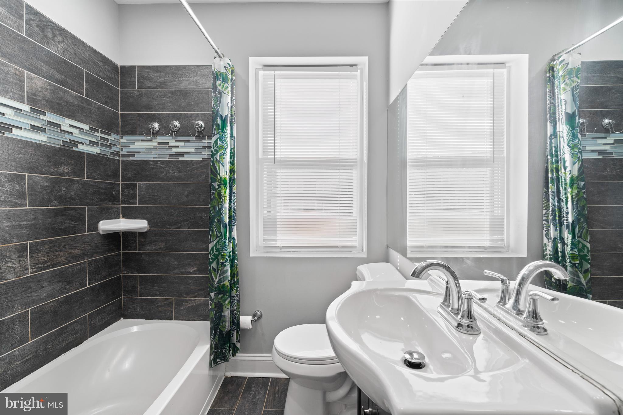 4237 Flowerton Road Baltimore, MD 21229 - Photo 14 of 27 a bathroom with a sink toilet and shower