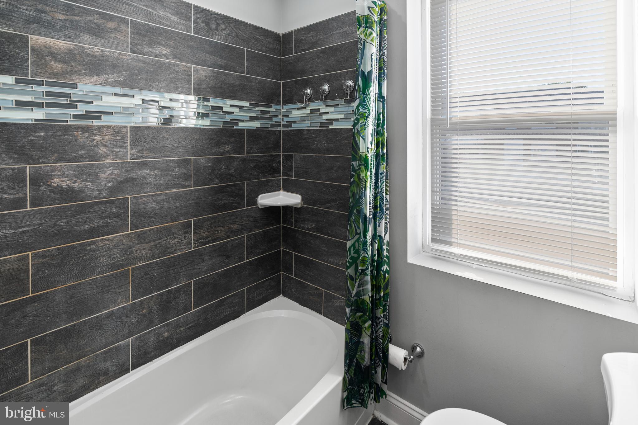 4237 Flowerton Road Baltimore, MD 21229 - Photo 15 of 27 a bathroom with a bathtub