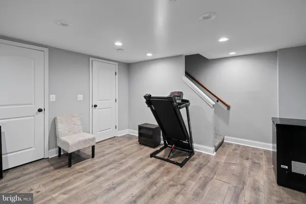 a view of a workspace with furniture and a wooden floor