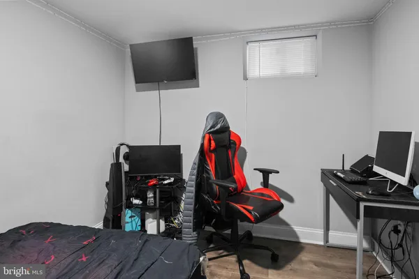 a view of a workspace with furniture and gym equipment