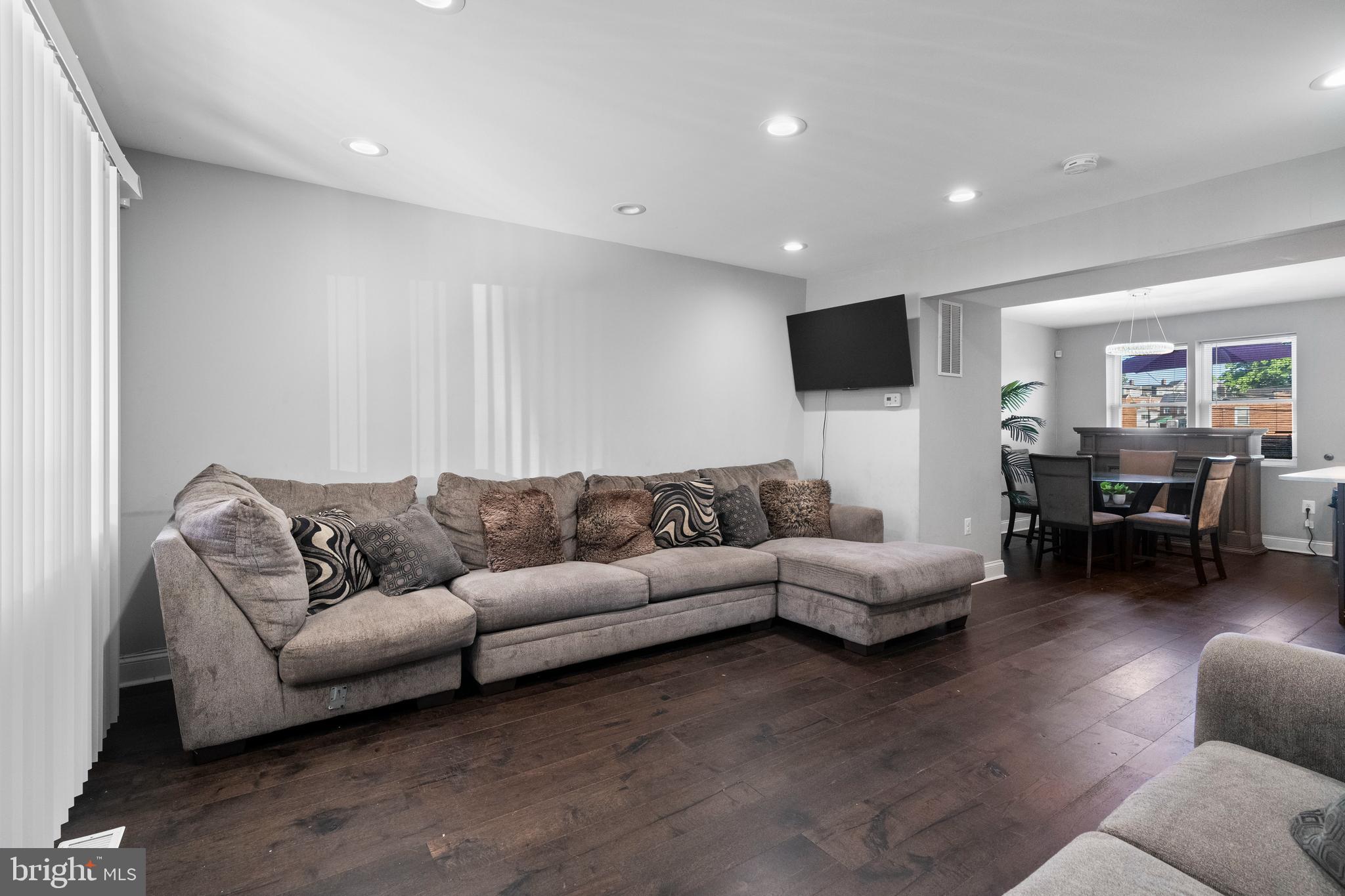 4237 Flowerton Road Baltimore, MD 21229 - Photo 3 of 27 a living room with furniture and a flat screen tv