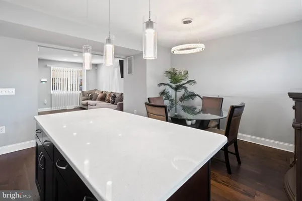 a view of kitchen island with stainless steel appliances cabinets