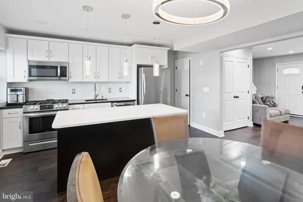 a kitchen with stainless steel appliances a sink and a refrigerator