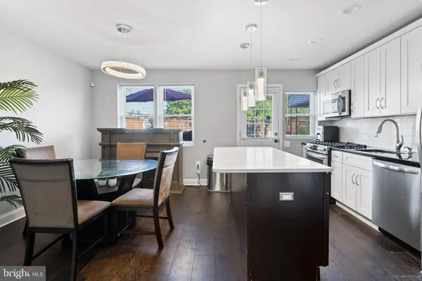 a kitchen with a table chairs stove and cabinets