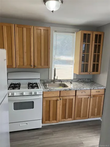 a kitchen with granite countertop a stove and a sink