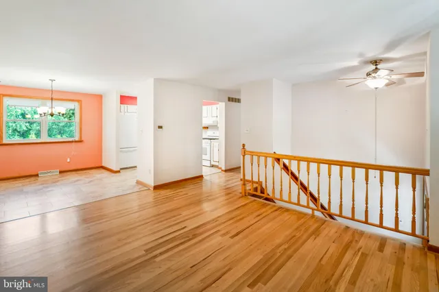 a view of a room with wooden floor and window