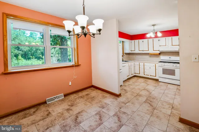 a kitchen with stainless steel appliances granite countertop a refrigerator sink and wooden floors