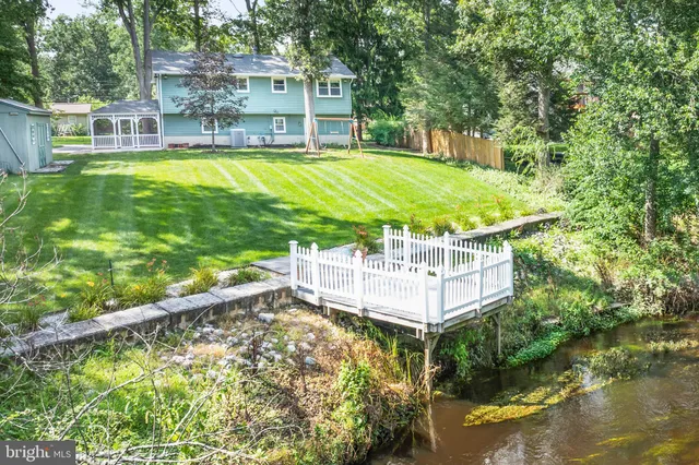 a swimming pool with outdoor seating and yard