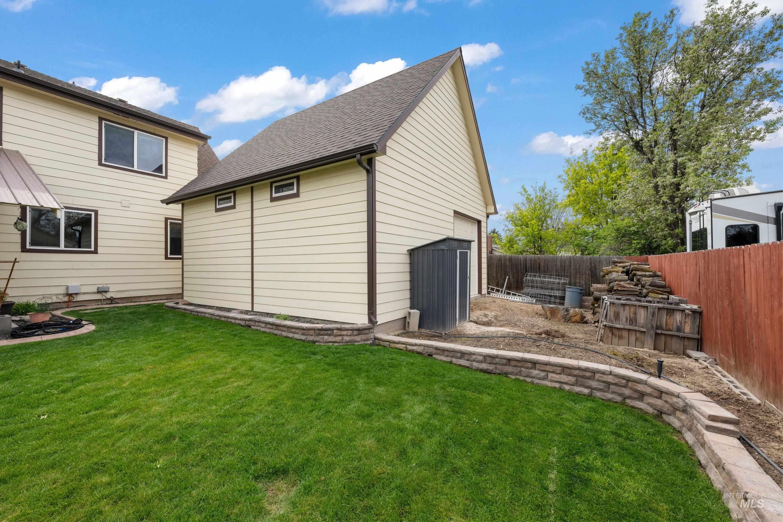 1921 Incline Way Meridian, ID 83646 - Photo 22 of 50 Expansive green lawn bordering a stone retaining wall