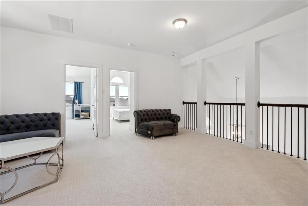 1710 Highwood Road Forney, TX 75126 - Photo 10 of 25 Spacious upper-level landing featuring light-toned carpeting and bright white walls