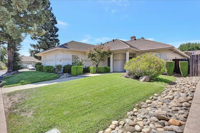 a front view of a house with garden