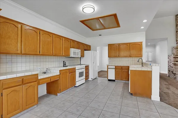 a kitchen with a sink and wooden cabinets