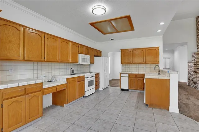 a kitchen with a sink and wooden cabinets