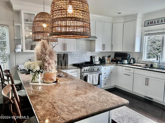 a kitchen with sink refrigerator and stove
