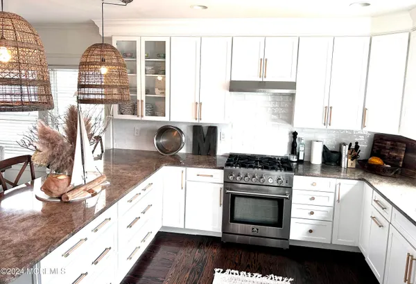 a kitchen with granite countertop a stove and a sink