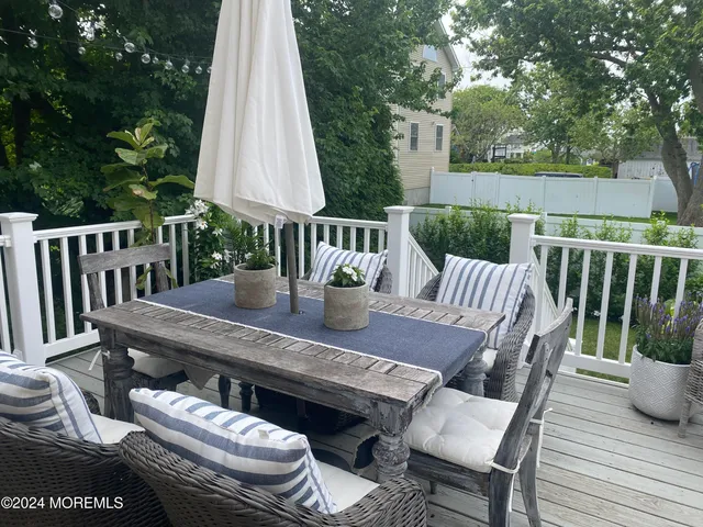 a view of a deck with furniture and a backyard