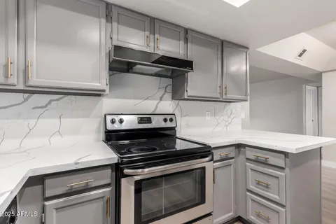 a kitchen with cabinets and appliances