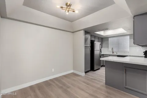 a view of a kitchen with a sink and a refrigerator