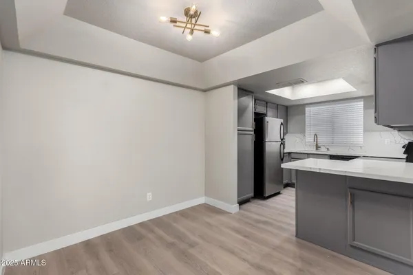 a view of a kitchen with a sink and a refrigerator
