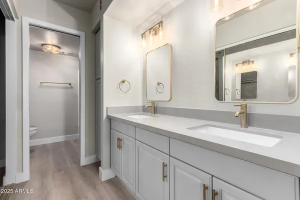 a bathroom with a double vanity sink and mirror