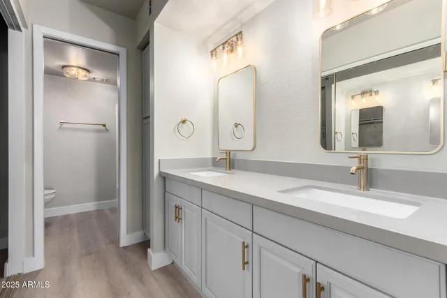 a bathroom with a double vanity sink and mirror