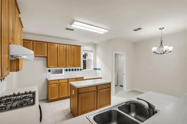 a kitchen with a sink stove and microwave